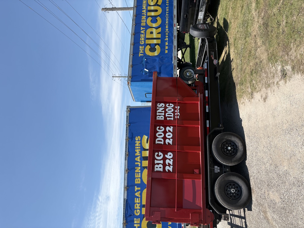 The red Big Dog Bins bin loaded on its trailer, ready to be delivered.